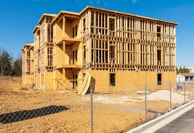 a close-up of temporary chain link fences enclosing a construction site, signaling progress in the project's development in Reedley